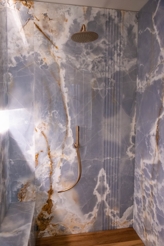 Portrait of the floor-to-ceiling shower, with a rain head and a hand shower